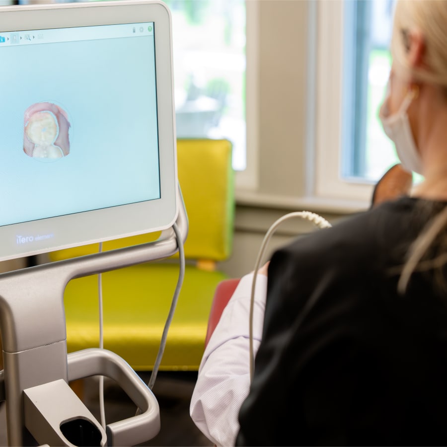 A Sturbridge Orthodontics team member takes a 3D scan of a patient's teeth.